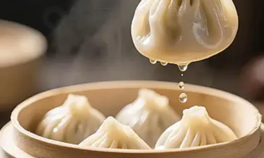 Steamed soup dumplings dripping broth in a bamboo steamer at Kung Fu Noodle House, a Chinese restaurant in West Allis